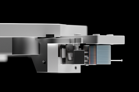 Close-up of a metallic hard drive actuator arm and read/write head against a black background.
