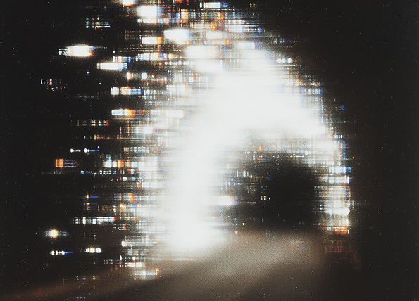 Bright, blurry white light arch with horizontal light streaks against a dark background.